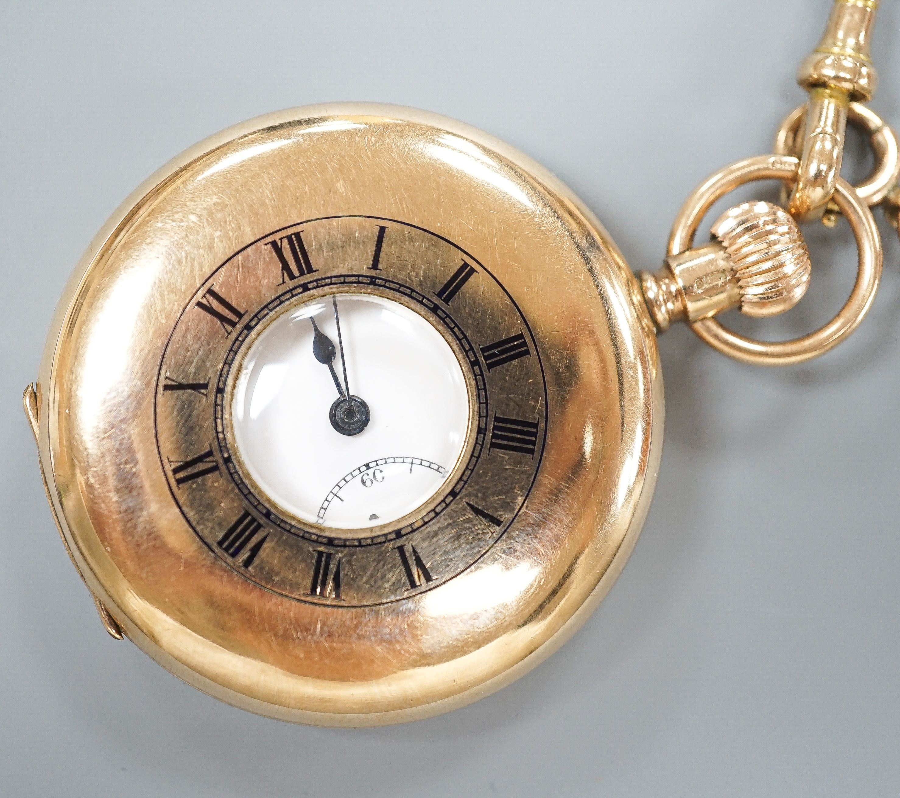 A George V 9ct gold half hunter pocket watch, 46mm, gross 74.9 grams, together with a 9ct gold cub link albert, 42cm, 21.2 grams.